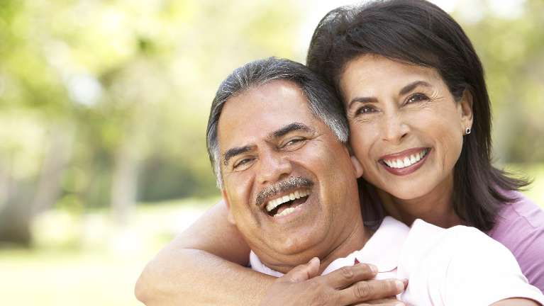 A man and wife hugging and smiling